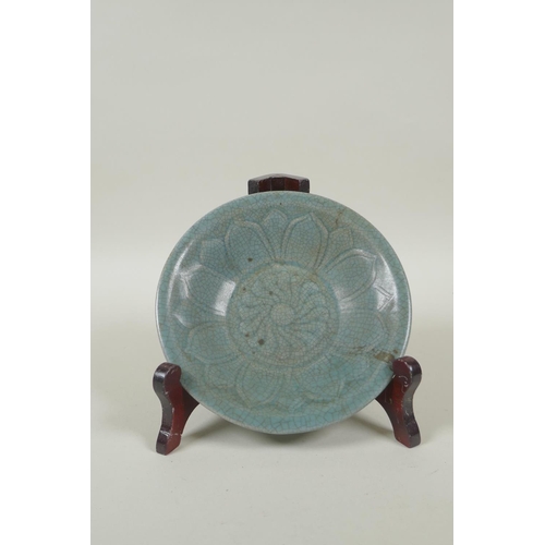 78 - A Chinese celadon crackleware bowl with incised lotus flower decoration, on a wood display stand, 16... 