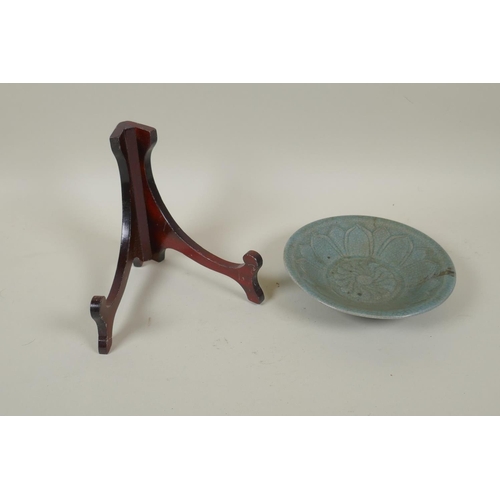 78 - A Chinese celadon crackleware bowl with incised lotus flower decoration, on a wood display stand, 16... 