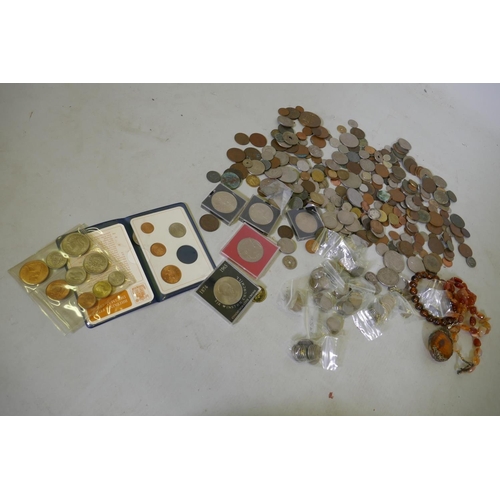 96 - A quantity of British and world coins, an agate necklace with amber style pendant inset with a scorp... 