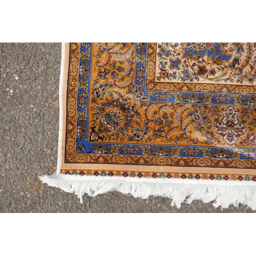 1144 - A fine silk Iranian cream ground rug with tradition floral medallion design, 152 x 226cm