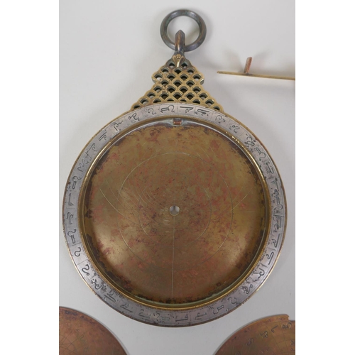 11 - An Islamic antique fine silver inlaid brass Astrolabe, with silver stars and five interchangeable do... 