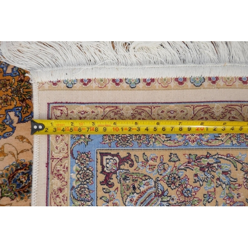 1144 - A fine silk Iranian cream ground rug with tradition floral medallion design, 152 x 226cm