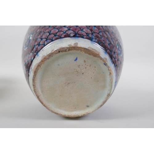 14 - An antique Persian blue and white glazed flask with boteh design, and another Perisan Iznik design p... 