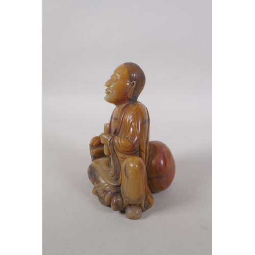 25 - A Chinese carved soapstone figure of Lohan, 14cm high