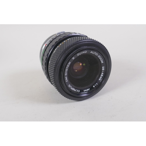 29 - An Olympus OM-4 Ti 35mm SLR camera, with two Olympus OM-system Zuiko lenses - OM 180mm F2.8 and OM 2... 