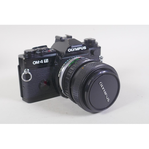 29 - An Olympus OM-4 Ti 35mm SLR camera, with two Olympus OM-system Zuiko lenses - OM 180mm F2.8 and OM 2... 