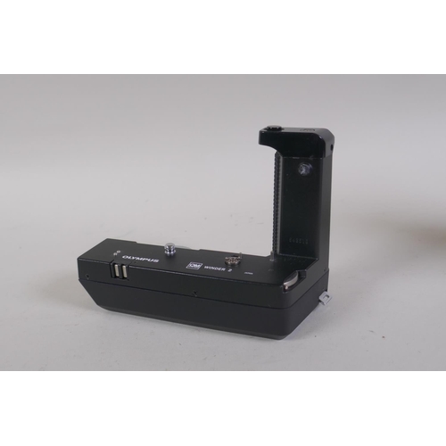 29 - An Olympus OM-4 Ti 35mm SLR camera, with two Olympus OM-system Zuiko lenses - OM 180mm F2.8 and OM 2... 