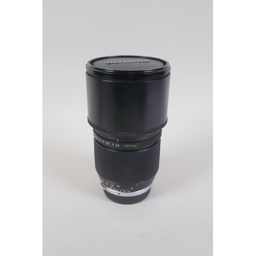 29 - An Olympus OM-4 Ti 35mm SLR camera, with two Olympus OM-system Zuiko lenses - OM 180mm F2.8 and OM 2... 