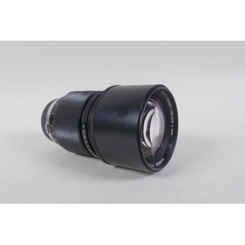 29 - An Olympus OM-4 Ti 35mm SLR camera, with two Olympus OM-system Zuiko lenses - OM 180mm F2.8 and OM 2... 