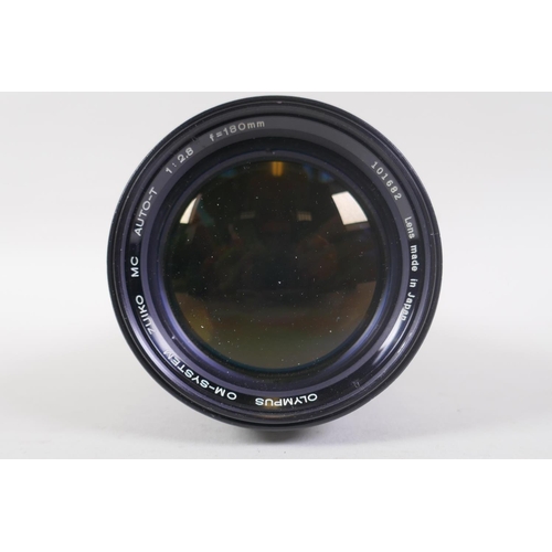 29 - An Olympus OM-4 Ti 35mm SLR camera, with two Olympus OM-system Zuiko lenses - OM 180mm F2.8 and OM 2... 