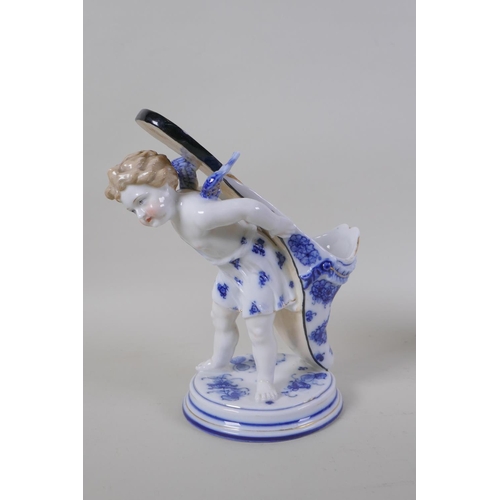 3 - A pair of early C20th continental porcelain posy holders/spoon warmers in the form of cherubs carryi... 