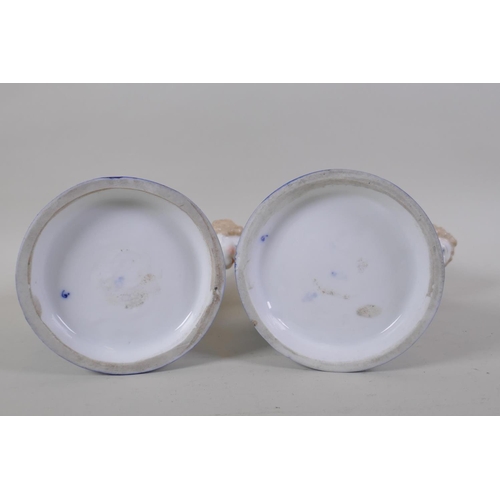 3 - A pair of early C20th continental porcelain posy holders/spoon warmers in the form of cherubs carryi... 