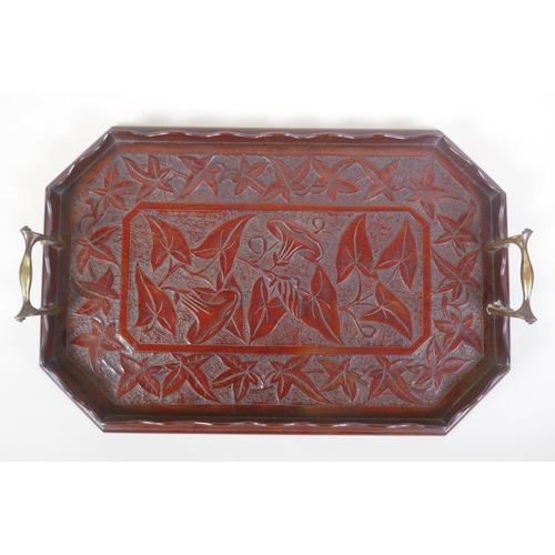 31 - An Arts & Crafts walnut tray with carved vine decoration and brass handles, 30 x 46cm
