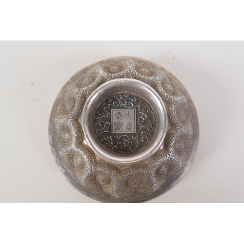 34 - A Chinese lotus shaped white metal ceremonial bowl, 4 character mark to base, 12cm diameter