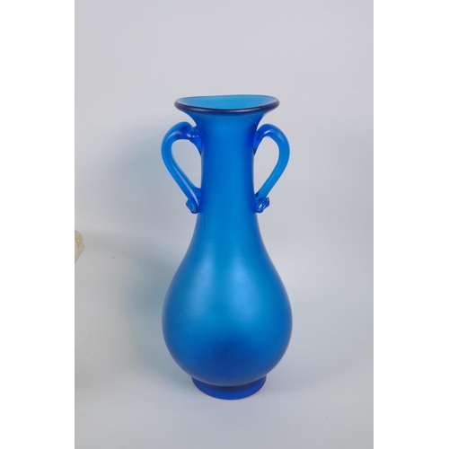 41 - A vintage art glass bottle vase, a hand blown two handled blue glass vase, and an iridescent art gla... 