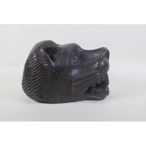 44 - An African Benin carved wood lion helmet/mask, 30 x 23cm