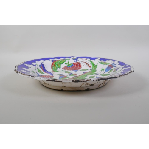 48 - A continental polychrome faience porcelain charger with lobed rim, decorated with an Iznik style des... 