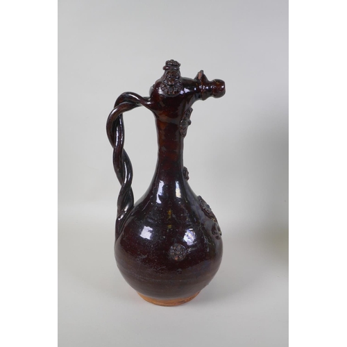 49 - An C19th Ottoman treacle glazed Canakkale pottery ewer with braided handle and applied floral decora... 
