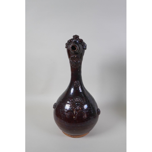 49 - An C19th Ottoman treacle glazed Canakkale pottery ewer with braided handle and applied floral decora... 
