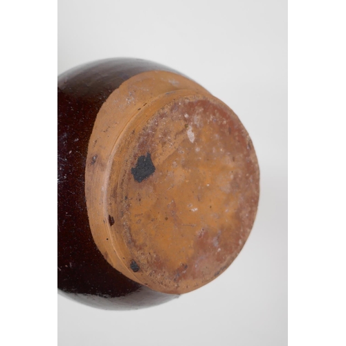 49 - An C19th Ottoman treacle glazed Canakkale pottery ewer with braided handle and applied floral decora... 