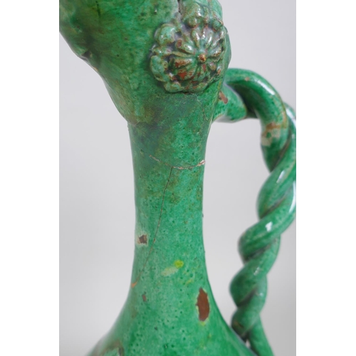 49 - An C19th Ottoman treacle glazed Canakkale pottery ewer with braided handle and applied floral decora... 
