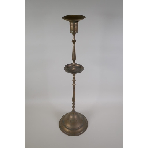 5 - An antique Ottoman brass candlestick, probably C18th, 69cm high