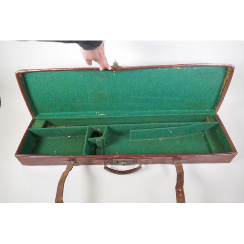 55 - A leather fitted shotgun case with cleaning rods, 84 x 23cm, 9cm high