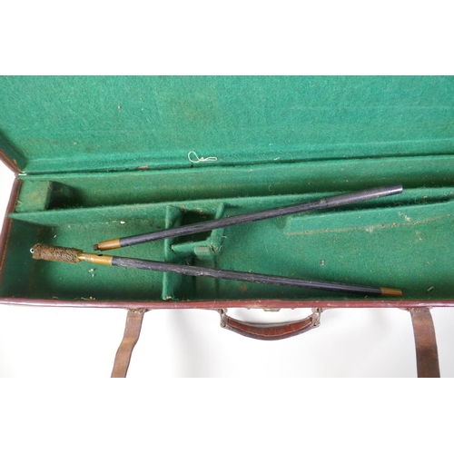 55 - A leather fitted shotgun case with cleaning rods, 84 x 23cm, 9cm high