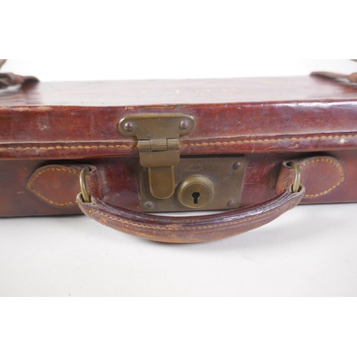 55 - A leather fitted shotgun case with cleaning rods, 84 x 23cm, 9cm high
