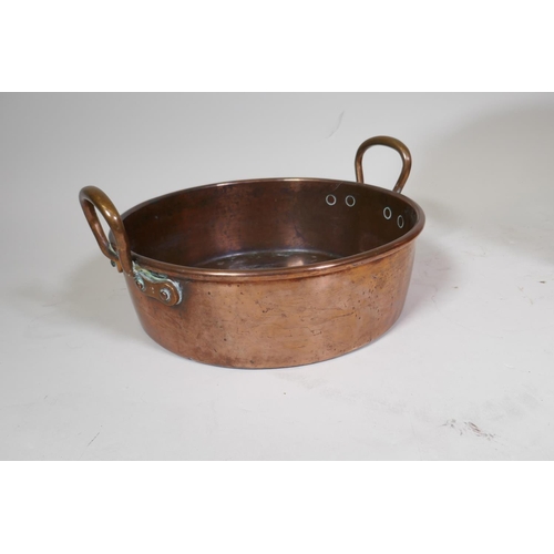 9 - An antique copper two handled jam pan, 37cm diameter, and an antique riveted copper bucket with bras... 