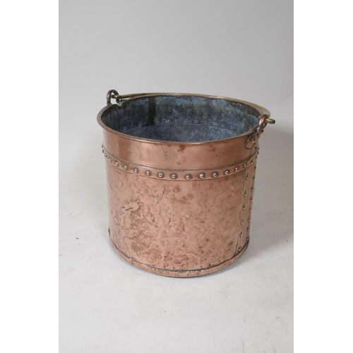 9 - An antique copper two handled jam pan, 37cm diameter, and an antique riveted copper bucket with bras... 