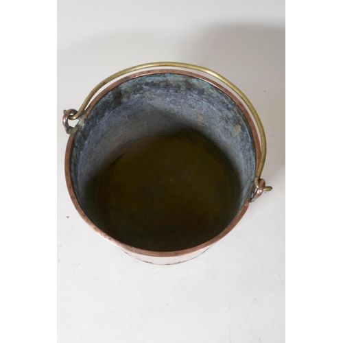 9 - An antique copper two handled jam pan, 37cm diameter, and an antique riveted copper bucket with bras... 