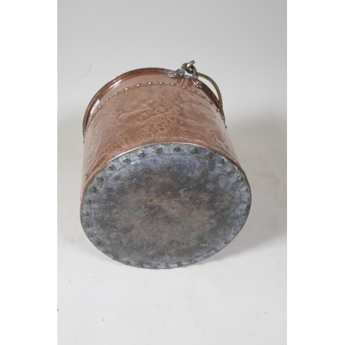 9 - An antique copper two handled jam pan, 37cm diameter, and an antique riveted copper bucket with bras... 
