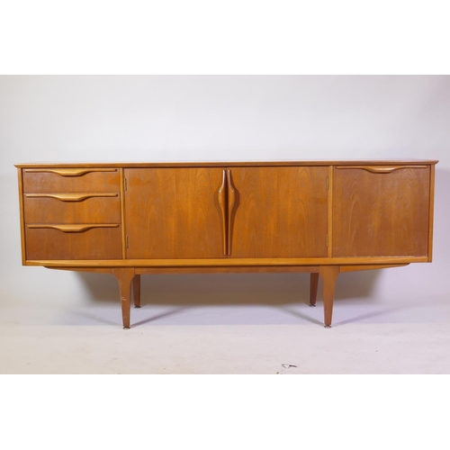 1021 - A Jentique mid-century teak sideboard with three drawers and fall front cupboard flanking two more, ...