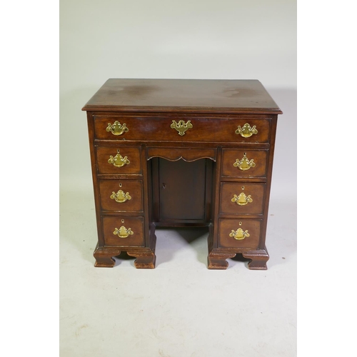 1001 - George II mahogany kneehole dressing table/desk with long drawer over two banks of three flanking a ...