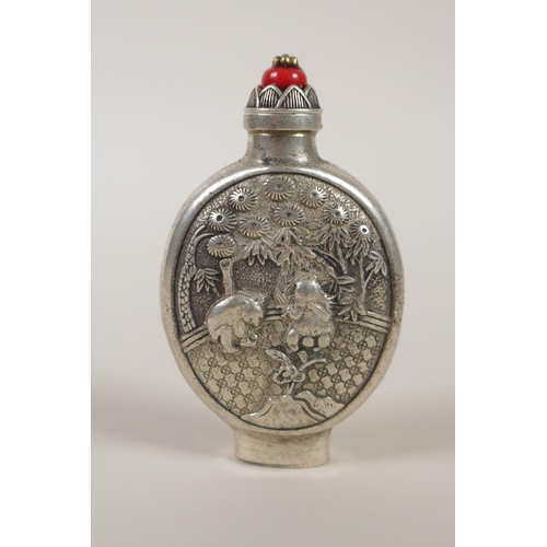 130 - A Chinese white met5al snuff bottle, with decorative raised panels depicting pandas, impressed marki... 