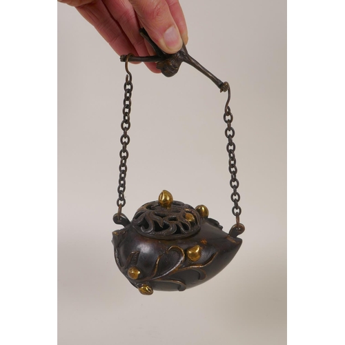 131 - A Chinese bronze peach shaped hanging censer, mark to base, 12cm long