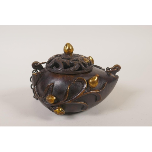 131 - A Chinese bronze peach shaped hanging censer, mark to base, 12cm long