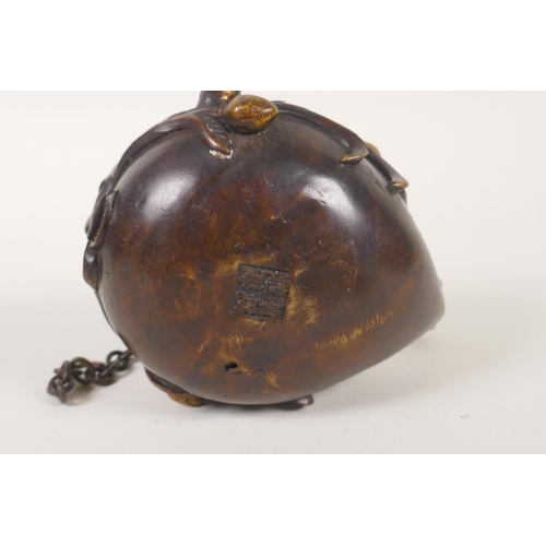 131 - A Chinese bronze peach shaped hanging censer, mark to base, 12cm long