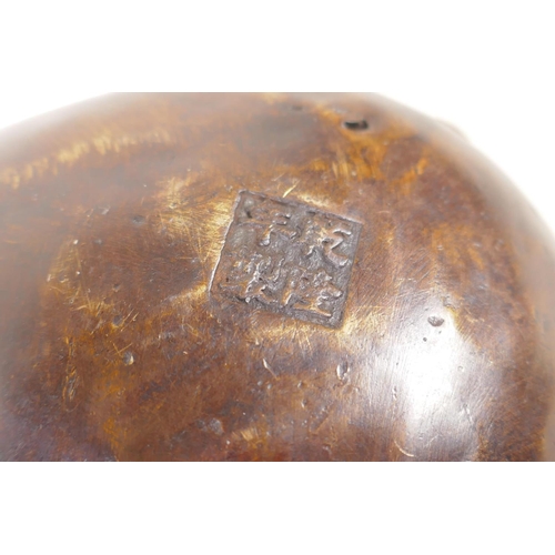 131 - A Chinese bronze peach shaped hanging censer, mark to base, 12cm long