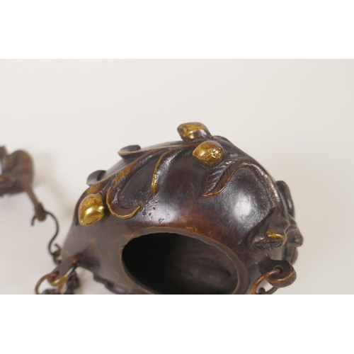 131 - A Chinese bronze peach shaped hanging censer, mark to base, 12cm long