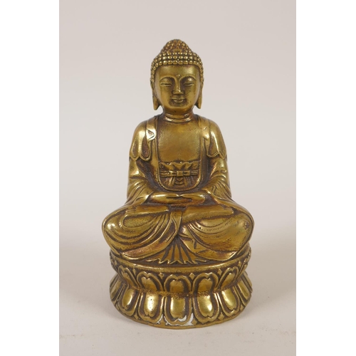 179 - A Sino-Tibetan filled gilt metal figure of Buddha, double vajra mark to base, 11cm high