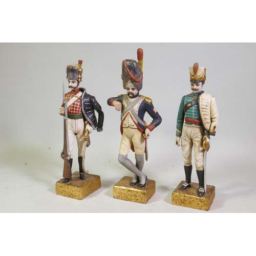 175 - Three carved wood figures of Napoleonic soldiers, with polychrome and parcel gilt decoration, 57cm h...