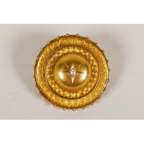 607 - A Victorian yellow metal mourning brooch with central set seed pearl, bears engraved dedication vers...