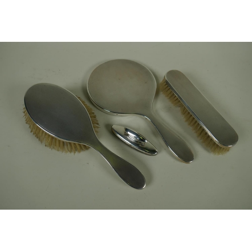 602 - A hallmarked silver dressing table set with engine turned decoration, London 1949, William Comyns Lt...