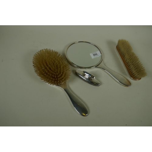 602 - A hallmarked silver dressing table set with engine turned decoration, London 1949, William Comyns Lt... 