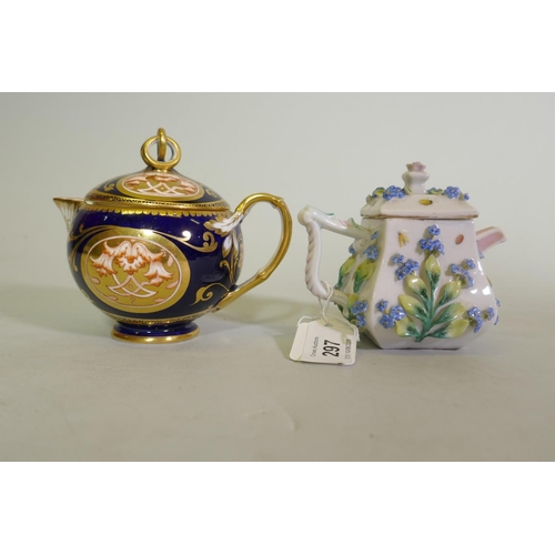 297 - A Continental Augustus Rex porcelain miniature teapot with raised floral decoration and a Vienna jug... 
