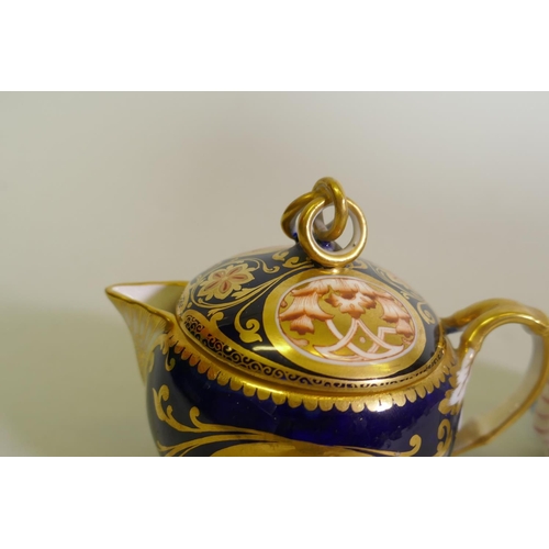 297 - A Continental Augustus Rex porcelain miniature teapot with raised floral decoration and a Vienna jug... 