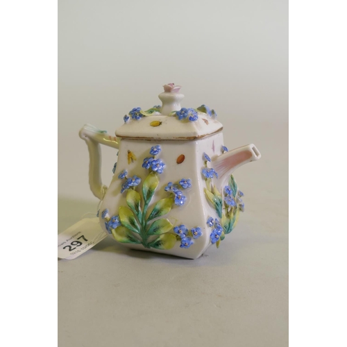 297 - A Continental Augustus Rex porcelain miniature teapot with raised floral decoration and a Vienna jug... 
