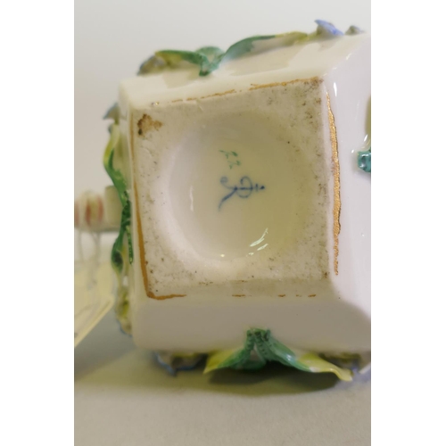 297 - A Continental Augustus Rex porcelain miniature teapot with raised floral decoration and a Vienna jug... 